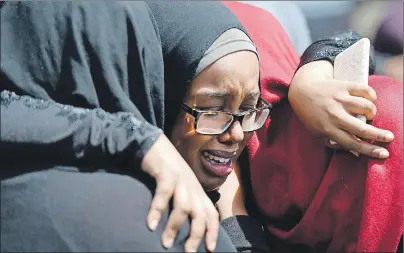  ?? CP PHOTO ?? A mourner cries after Friday’s funeral for Abdirahman Abdi, who died after an altercatio­n with Ottawa Police on Sunday.