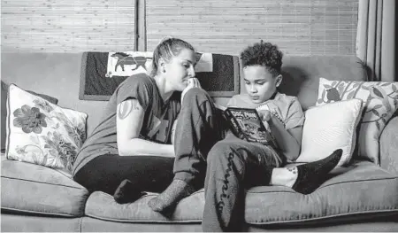  ?? NIC ANTAYA/THE NEW YORK TIMES ?? Caitlin Reynolds and her son, L.J., at home Nov. 30 in Royal Oak, Mich. She is out of paid time off as schools close temporaril­y.