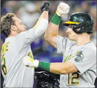  ?? Frank Gunn The Associated Press ?? Sean Murphy, right, celebrates his third-inning home run with Athletics teammate Jed Lowrie in Oakland’s win over Toronto at Rogers Centre.