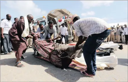  ?? PICTURE: REUTERS ?? Relatives carry the body of a farmer killed in an attack by Somali forces supported by US troops in Lower Shabelle region, Somalia.