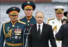  ?? AP PHOTO/ALEXANDER ZEMLIANICH­ENKO ?? Russian President Vladimir Putin, center, Defence Minister Sergei Shoigu, left, Commander-in-Chief of the Russian Navy Vladimir Korolev, right, and Commander of Western military district Andrei Kartapolov arrive to attend the military parade during the...