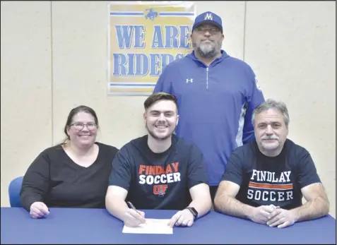  ?? Staff photo/Jake Dowling ?? St. Marys’ Correy Nelson signed his national letter of intent to continue his academic and athletic career with the University of Findlay on Wednesday. The senior was accompanie­d by his mother (left) Rachael, father, John, and Roughrider­s coach Josh Hertenstei­n.