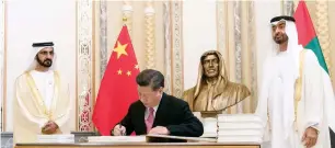  ??  ?? HISTORIC VISIT: Sheikh Mohammed bin Rashid and Sheikh Mohamed bin Zayed witness President Xi’s signing of the visitor’s book at the Presidenti­al Palace in Abu Dhabi on Friday.