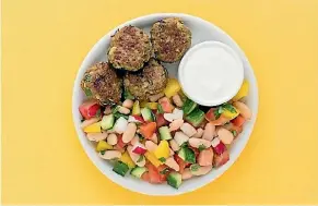  ??  ?? Greek-spiced lamb cakes with cucumber, tomato and radish salad.