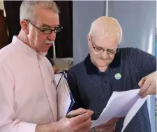  ??  ?? Councillor Declan Bree and Pat Fallon mull over the tally figures