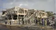  ?? FARAH ABDI WARSAMEH/THE ASSOCIATED PRESS ?? Somali security forces and others search for bodies at the scene of Saturday’s massive bomb blast in Mogadishu.