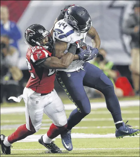  ?? JOHN BAZEMORE / ASSOCIATED PRESS ?? Rookie strong safety Keanu Neal (left), tackling Seahawks fullback Marcel Reece, epitomizes Atlanta’s defensive mentality. “I’m here to play hard and hit hard,” the 2016 first-round draft pick says.