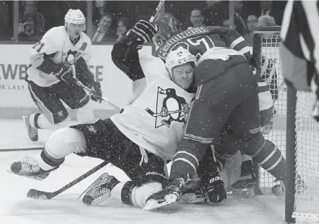  ?? JULIE JACOBSON/THE ASSOCIATED PRESS ?? Penguins left wing Chris Kunitz collides with Rangers defenceman Ryan McDonagh during the first period of Game 4 in New York on Thursday.