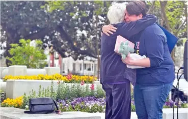  ?? AP PHOTO/KIM CHANDLER ?? Deanna Smith, wife of the first person to be executed in Alabama by nitrogen gas, hugs Esther Brown of Project Hope to Abolish the Death Penalty, after a rally Thursday in Montgomery, Ala.