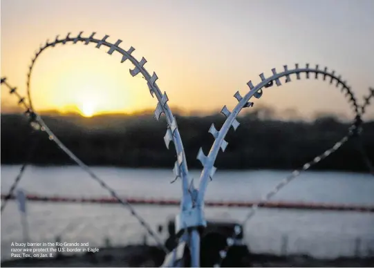  ?? JAY JANNER Austin American-Statesman/USA TODAY NETWORK ?? A buoy barrier in the Rio Grande and razor wire protect the U.S. border in Eagle Pass, Tex., on Jan. 8.