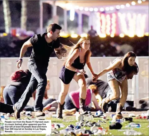  ?? DAVID BECKER/GETTY IMAGES/AFP ?? People run from the Route 91 Harvest country music festival after apparent gun fire that left at least 58 people dead and more than 500 injured on Sunday in Las Vegas, Nevada.