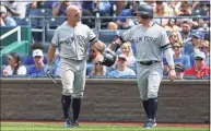  ?? Scott Winters / Icon Sportswire via Getty Images ?? The Yankees’s Brett Gardner, left, and Clint Frazier fist-bump after scoring during a 2019 against the Royals in Kansas City.
