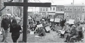  ?? CATHERINE RENTZ/BALTIMORE SUN ?? Dozens gather along 36th Street in front of St. Luke’s Evangelica­l Lutheran Church in Hampden to honor stabbing victim Timothy Caughman and express community solidarity.