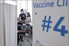  ?? AP file photo ?? Graham Roark, 8, receives the Pfizer COVID-19 vaccine for children 5 to 11 years from Lurie Children’s hospital registered nurse Virginia Scheffler at the hospital Nov. 5 in Chicago. First shots are averaging about 300,000 per day.