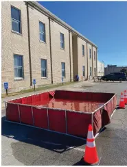  ?? (Pine Bluff Commercial/Byron Tate) ?? A temporary water trough has been placed in the parking lot of the Jefferson County Courthouse. The water is used to flush toilets in the building because the water pressure is too low. “Every office has a bucket,” one worker said.