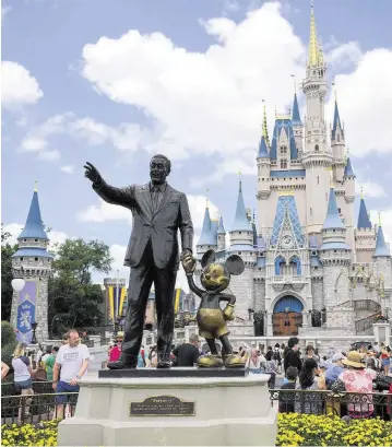  ?? ALLIE GOULDING Tampa Bay Times ?? The ‘Partners’ statue, featuring Walt Disney and Mickey Mouse, is in front of Cinderella’s Castle at Magic Kingdom at Disney World in Orlando.