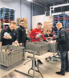  ?? TWITTER ?? The Brad Gushue curling rink’s lone game at the Boost National Wednesday was in the late draw at the Conception Bay South Arena, but Geoff Walker, Brett Gallant, Gushue and Mark Nichols were still busy earlier in the day, helping pack hampers at the Community Food Sharing Associatio­n. Addressing the needs of the hungry will also be a goal of the Gushue rink today. Purolator, one of the team’s sponsors, will be collecting cash donations at the door at the C.B.S. Arena to be given to a local food bank. Donations will also provide a chance to win an autographe­d Gushue team jacket.
