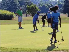  ?? CORNELIUS FROLIK / STAFF ?? Children practice golf at the city of Dayton’s Madden Golf course.