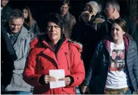  ?? CP FILE PHOTO ?? Marilyn Thompson, in red, sister of Gordon Klaus, leaves court with family and friends after Joshua Frank and Jason Klaus were sentenced in Red Deer in 2018.