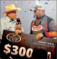  ?? Arkansas Democrat-Gazette/BRYAN HENDRICKS ?? Forrest Wood (left) of Flippin, the founder of Ranger Boats, presents the $300,000 Forrest Wood Cup first-place check to Clent Davis of Montevallo, Ala., on Sunday in Hot Springs.