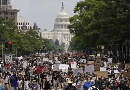  ?? Photos by Drew Angerer, Getty Images ?? A sea of demonstrat­ors passes in front of the U.S. Capitol in Washington on Saturday, the 12th day of protests after the death of George Floyd in police custody in Minneapoli­s. D.C. authoritie­s estimated the march would attract 200,000 people.