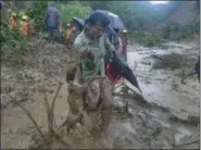  ?? THE ASSOCIATED PRESS ?? A man carries the carcass of a goat as rescuers search amid the mud after a landslide in Bandarban, Bangladesh, Tuesday.