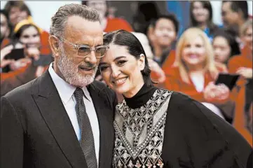  ?? GEOFF ROBINS/GETTY ?? Actor Tom Hanks and director Marielle Heller at the premiere of “A Beautiful Day in the Neighborho­od” Sept. 7 in Toronto.