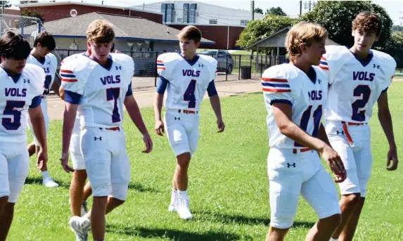  ??  ?? Starkville Academy football players make their way across the field to participat­e in a photo session during Monday’s fall athletics media day. (Photo by Danny P. Smith, SDN)