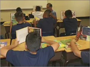  ?? WILLIAM ROLLER PHOTO ?? Students at Desert Garden Elementary School enjoy reading their selections during the book giveaway as part of the Kiwanis literacy project organized by the Kiwanis Club of Early Risers and the Salvation Army in El Centro on Thursday.