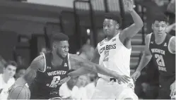  ?? SUE OGROCKI ?? Wichita State’s Jamarius Burton, left, drives around Oklahoma State’ Chris Harris Jr. on Dec. 8 in Stillwater, Okla. Wichita State (10-1) is the leading vote-getter among unranked teams.