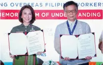  ?? CONTRIBUTE­D PHOTO ?? Department of Tourism Secretary Christina Garcia Frasco (left) and Department of Migrant Workers Officer in Charge Secretary Hans Leo Cacdac sign a memorandum of understand­ing to build a program for overseas Filipino workers.