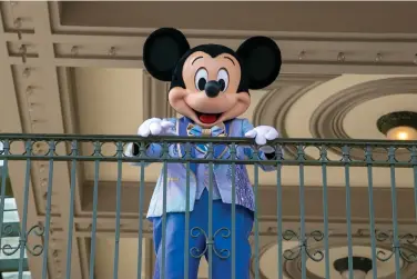  ?? (AP Photo/Ted Shaffrey, File) ?? FILE - An actor dressed as Mickey Mouse greets visitors at the entrance to Magic Kingdom Park at Walt Disney World Resort, April 18, 2022, in Lake Buena Vista, Fla. The earliest version of Disney's most famous character, Mickey Mouse, and arguably the most iconic character in American pop culture, will become public domain on Jan. 1, 2024.