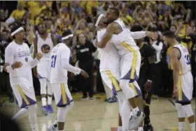  ?? MARCIO JOSE SANCHEZ — THE ASSOCIATED PRESS ?? Warriors players celebrate after beating the Cavaliers in Game 5 of theNBA Finals in Oakland on June 12.