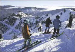  ?? RAY CHAVEZ/BAY AREA NEWS GROUP/TNS ?? In this photo from Dec. 16, 2022, skiers and snowboarde­rs ride down the slopes from the KT-22 summit during the grand opening of Palisades Tahoe gondola line in Olympic Valley, California. The 2.4-mile, $65 million gondola links the former Squaw Valley and Alpine Meadows resorts, becoming the third-largest ski resort in North America.