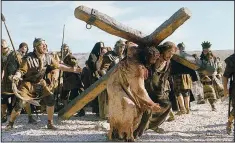  ?? AP/PHILIPPE ANTONELLO ?? Jim Caviezel (center), who portrayed Jesus Christ in the 2004 movie The Passion of the Christ, appears in Paul, Apostle of Christ, which debuted Friday. In an attempt to draw larger audiences to Christian-theme movies that no longer stand out as a...