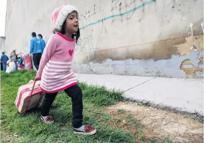  ?? PHOTO: REUTERS ?? Uprooted . . . A Venezuelan migrant girl heads to the exit of a makeshift camp with her belongings in Bogota, Colombia.