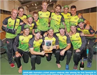  ?? — AFP ?? AUCKLAND: Australia’s cricket players celebrate after winning the final Twenty20 Tri Series internatio­nal cricket match between New Zealand and Australia at Eden Park in Auckland yesterday.