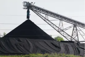  ??  ?? OMAHA: A hill of coal is seen at the North Omaha Station, a coal-burning power station, in Omaha, Neb. The Environmen­tal Protection Agency has will announced a preferred range of 65 to 70 parts per billion to reduce the amount of smog-forming pollution...