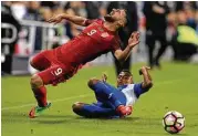  ?? Sean M. Haffey / Getty Images ?? American Sebastian Lletget, left, goes down with an injury after a tough challenge by Honduras’ Ever Alvarado, who was given a yellow card Friday.