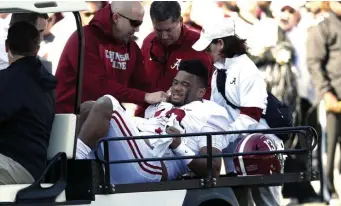  ?? AP ?? TOUGH GAME: Alabama quarterbac­k Tua Tagovailoa is carted off the field after getting injured against Mississipp­i State.