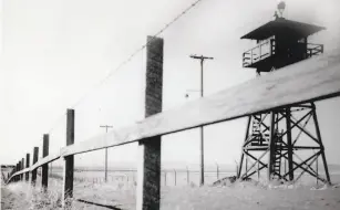  ?? Fred Larson / The Chronicle ?? Above left, Japanese Americans recite the Pledge of Allegiance at school before being sent to a camp; above right, people line up for a train to a camp. Above, a view of the Tulelake internment camp; below, the order requiring Japanese Americans to...