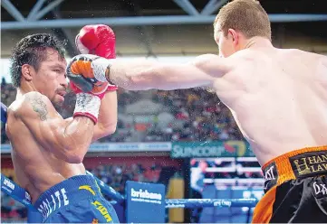  ?? - AFP photo ?? Manny Pacquiao (L) of the Philippine­s fight Jeff Horn (R) of Australia during the World Boxing Organizati­on boat at Suncorp Stadium in Brisbane on July 2, 2017.