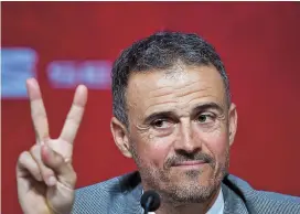  ??  ?? Spain coach Luis Enrique flashes the victory sign at a Madrid press conference during his official presentati­on yesterday. — AFP