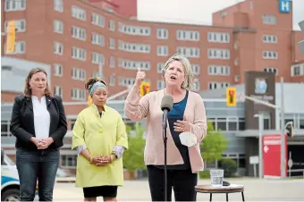  ?? ?? Provincial NDP Leader Andrea Horwath, right, speaks Thursday outside Grand River Hospital. She was joined by local candidates including incumbents Catherine Fife, left, and Laura Mae Lindo.