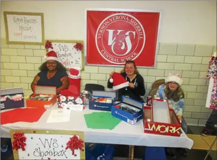  ?? PHOTOS SPECIAL TO THE DISPATCH BY MIKE JAQUAYS ?? VVS Shoebox Santas, including, from left, Vernon-Verona-Sherrill Central School students Claire Mumford, Baylee Reader, and Bridgett Finnerty describe their outreach to guests at the VVS Community Day on Oct. 16at the Verona school.