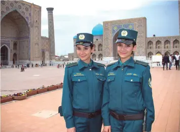  ??  ?? Identical twins Zukhra and Fatima Rakhmatova, 30, members of a newly-formed Tourist Police, posing in the famed silk road city of Samarkand. — AFP photos