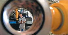  ?? XINHUA ?? An employee works at the production line of a machinery company in Jinan, Shandong province. The province is adopting new technology to update its traditiona­l industries.