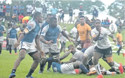  ?? Waisea Nasokia ?? Nadroga halfback Joseva Kuricuva flicks a pass as the Nadi players close in druring their Skipper Cup clash at Lawaqa Park, Sigatoka, on October 17, 2020. Photo: