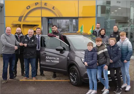  ??  ?? Kerry GAA treasurer Tom Keane presenting the keys of a new Opel car to John Griffin from Cahercivee­n, who was the winner of the Kerry GAA Car Draw sponsored by Ahern’s Opel Dealer, Castleisla­nd. From left: John Griffin, Seamus Murphy (Ahern’s), Tom Keane, Pat Ahern Ahern’s), Jack Sherwood (Kerry footballer), Kevin, Kieran, Rachel and Jack Griffin, Barry Ryan (Ahern’s), Mary Griffin and Eamon Whelan (Kerry GAA). Photo by Joe Hanley