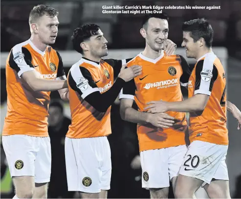  ??  ?? Giant killer: Carrick’s Mark Edgar celebrates his winner against Glentoran last night at The Oval